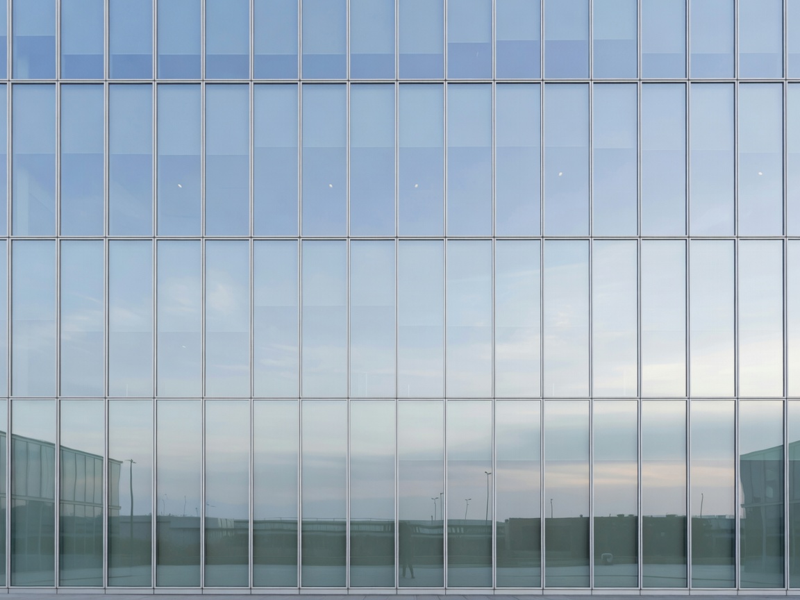 Modern corporate architectural facade reflecting subtle sky light